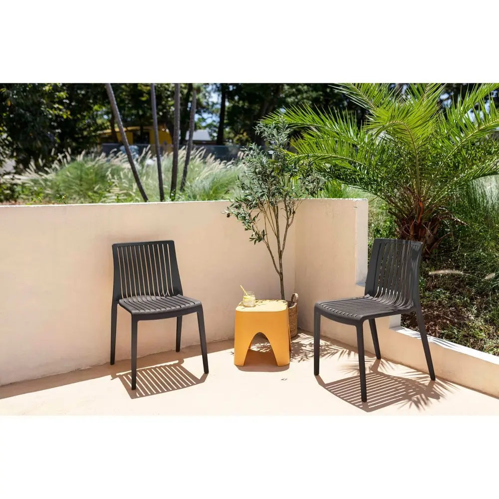 Set of Two Black Heavy Duty Plastic Outdoor Stacking Accent Chairs - NOBLE HOME INTERIORS